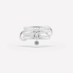 The Piera linked ring is comprised of three linked bands and features a trio of annulets with a central drop charm. Each ring in either 18k gold or .925 sterling silver is paired with a bezel-set stone in striking contrast and tactile appeal. Each Piera linked ring is individually handmade in Los Angeles. Modern Twist White Gold Jewelry With Ring Detail, Timeless Double Band Ring With Detail, Timeless Double Band Ring Jewelry, White Gold Jewelry With Double Band Ring Detail, Timeless Silver Stackable Rings With Bezel Setting, Timeless Silver Stackable Double Band Rings, Timeless Silver Double Band Stackable Rings, Linked Rings, Galaxy Ring