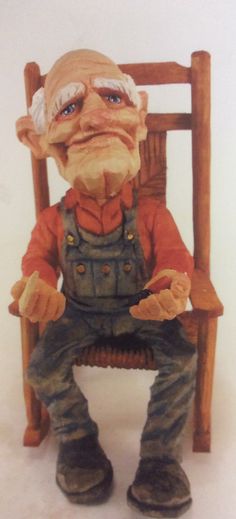 an old man sitting in a wooden chair