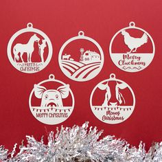 four christmas ornament designs on a red background with tinsel in the foreground