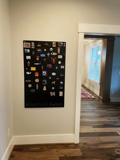 there is a black and white poster on the wall in this room with wood flooring