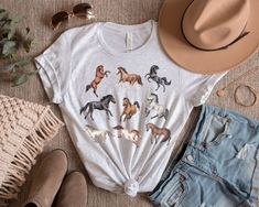 Beautiful Horses tee. I like to dress up these t-shirts with a nice denim jacket. For our Tee shirts we use the Bella Canvas brand. Our unisex tees are super soft 100% Airlume combed and ring-spun cotton. (Heather Peach:52% Airlume combed and ring-spun cotton, 48% poly. Athletic Heather:90% Airlume combed and ring-spun cotton, 10% poly.) Sweatshirt details: 50% Cotton 50% Polyester, Medium-heavy fabric (8.0 oz/yd² (271.25 g/m Loose fit, Runs true to size. *Please make sure you check our size-chart before you place your order.* If you have any questions feel free to message us 😊 HOW TO ORDER 1. Please, Check and Review all Photos. 2. Select Your T-Shirt Size and T-Shirt Color from drop down menus. 3. Choose Your Quantity as much as you want. 4. Click ADD TO CART. If you are ordering more t Western Style T-shirt For Spring Ranch, Fitted Western Style T-shirt For Summer, Western Pre-shrunk Tops For Summer, Country Style T-shirt For Rodeo In Spring, Country Style Shirt For Summer Rodeo, Casual White Tops For Country Events, Fitted T-shirt For Rodeo In Fall, Casual Summer T-shirt For Ranch, Casual Summer Outdoor T-shirt