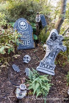 an outdoor cemetery with tombstones and skulls on the ground, surrounded by plants and trees