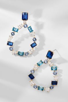 Elevate your look with these statement-making earrings! Showcasing an intricate mix of unique, mixed-cut clear CZ and blue stones, blending luxury and style for a must-have earring set. Blue Cubic Zirconia Crystal Earrings, Blue Crystal Pierced Earrings, Blue Crystal Drop Earrings, Blue Drop Crystal Earrings, Blue Sparkling Dangle Earrings, Blue Cubic Zirconia Drop Earrings, Blue Jeweled Drop Earrings, Blue Cubic Zirconia Earrings With Sparkling Stones, Blue Dangle Earrings With Sparkling Stones