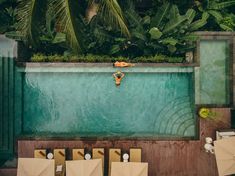 an empty swimming pool surrounded by tables and umbrellas