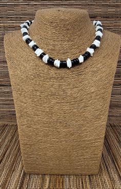 "Black and White Puka shell Necklace. Handmade with white seashell and black wooden beads 17\" Inches Around the neck Handmade Design. Necklace is Unisex Fits Most Sizes FAST SHIPPING! *First Class Mail* Visit my Etsy Shop to see more Designs! Handmade Earrings, Puka Shell Bracelets and Puka Shell Necklaces. Click here to see more designs: https://www.etsy.com/shop/FreedomLifeStyle" Black Round Beads Jewelry For Beach, Black Necklaces With Large Beads For Beach, Black Beaded Necklace For Vacation, Black Wooden Beads Necklace For Beach, White Necklace With Black Beads For Beach, Handmade Black Necklace For Beach, Black Round Bead Jewelry For Vacation, Handmade Black Necklace For The Beach, Black Round Beads Jewelry For Vacation