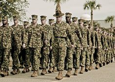 a group of soldiers marching down the street