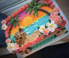 there is a cake decorated with flowers and a turtle