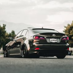 a black car is parked on the street