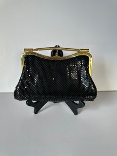 A lovely vintage black and white handbag in the style of Whiting and Davis from the 1960s or 70s. Honeycomb aluminium mesh gold evening bag, that you can wear as a clutch or as a shoulder bag. There is one zippered pocket inside.  The black tone strap is concealable or removable. The inside fabric lining is black.  The tag is marked "Aluminum Mesh Metal, Made in Hong Kong". Approximate measurements: 6" high 8 3/8" wide 2" deep Strap drop is 18" It is in very good vintage condition.  Please feel Black Retro Rectangular Evening Bag, Retro Black Rectangular Evening Bag, Vintage Black Evening Bag For Party, Black Retro Bag For Party, Retro Black Party Bag, Black Retro Party Bag, Retro Black Party Bags, Vintage Evening Bag With Detachable Handle For Party, Retro Vintage Black Evening Bag