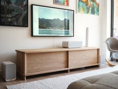 an entertainment center with speakers and pictures on the wall