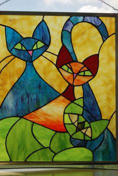 a stained glass window with two cats on it