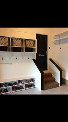 the entryway is clean and ready to be used as a shoe storage area for shoes