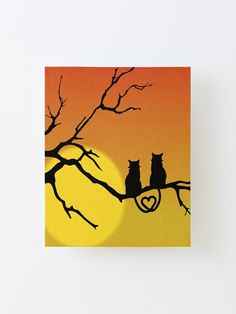 two cats sitting on a tree branch in front of a full moon with the sun behind them