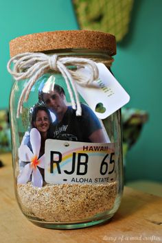 a mason jar with a photo in it and a tag attached to the lid that says rjb 65