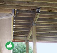 the underside of a wooden structure with a thumbs up sign