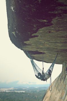 a hammock hanging from the side of a cliff