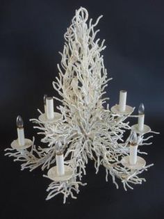 a white coral chandelier with candles