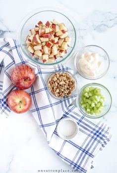 apples, celery, yogurt and other ingredients are arranged on a table