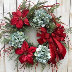 a christmas wreath with red and green flowers