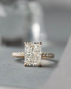 a diamond ring sitting on top of a table