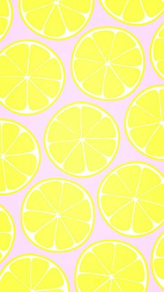 a group of lemons cut in half on a pink background