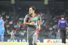 a cricket player is walking on the field