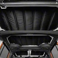 the inside of a car with its door open and seats folded down in front of it