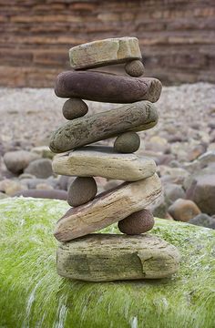 a pile of rocks sitting on top of green moss