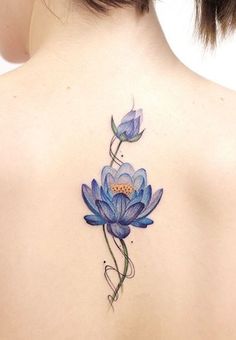 the back of a woman's shoulder with blue flowers painted on her upper body