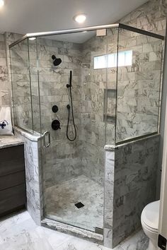 a walk in shower sitting inside of a bathroom