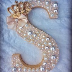 the letter s is decorated with pearls and a crown