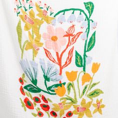 a white shirt with colorful flowers on it