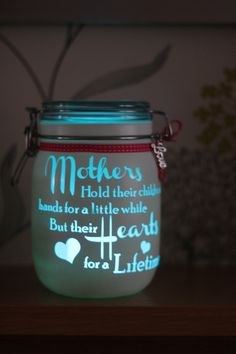 a light up jar that has some words on it and is sitting on a shelf