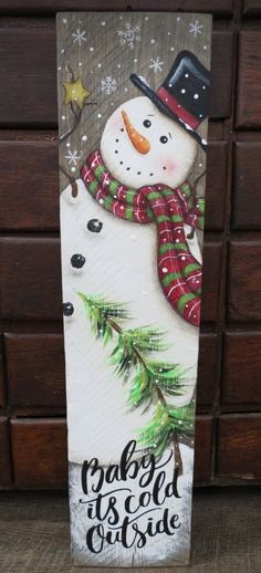 a wooden sign with a snowman wearing a hat and scarf