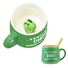 there is a green mug with a toy frog in it