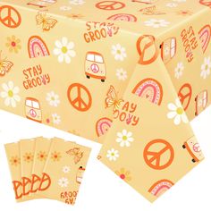 the table cloth has peace signs, flowers and hippies on it with words stay grooy