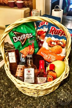 a basket filled with lots of food on top of a counter next to a bag of chips