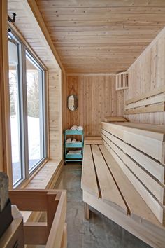 a room with wooden walls and benches in it