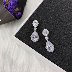 "These stud bridal earrings are stunning for bridal occasions whether you want a vintage or classic look. These beauties are designed with encrusted crystals and high quality AAA+ cubic zirconia that glistens on the ear. They come in a sparkling silver, gold or rose gold finish to give an elegant look. These gorgeous earrings will be carefully wrapped and arrive in a logo gift box. Visit my shop for care instructions and more bridal accessories ➔ https://www.etsy.com/shop/BlushandIvoryStudio Mea Diamond Clip-on Earrings With Sparkling Stones For Wedding, Wedding Clip-on Earrings In Diamond White Cubic Zirconia, Classic Diamond White Chandelier Earrings For Wedding, Elegant Wedding Clip-on Earrings With Sparkling Stones, Elegant Crystal Clip-on Earrings For Wedding, Classic Crystal Bridal Earrings For Evening, Anniversary Crystal Chandelier Drop Earrings, Classic Evening Bridal Earrings In Crystal, Crystal Drop Cluster Earrings For Wedding