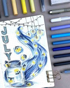 a notebook with an image of a jar and lights hanging from the strings, surrounded by crayon markers