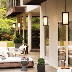 an outdoor living area with couches and tables