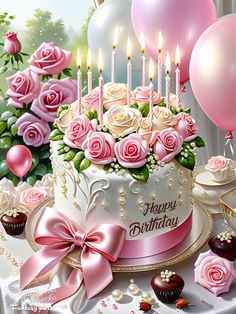 a birthday cake with pink roses and candles on it, surrounded by cupcakes