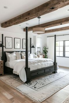 a large bed sitting in the middle of a bedroom on top of a wooden floor