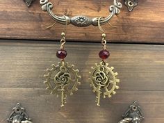 Bronze Steampunk style earrings with gears and a rose ornamented key. The earrings are finished off with dark red crystal beads. Earrings Industrial, Gear Earrings, Industrial Earrings, Key Earrings, Steampunk Earrings, Earrings Dangling, Steampunk Style, Dangling Earrings, Red Crystals