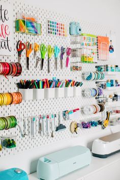 there are many different items on the pegboard attached to the wall behind the crafting supplies