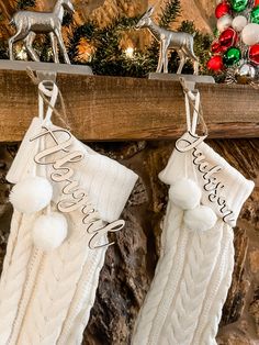 two christmas stockings hanging from a mantel