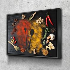 an art piece with spices, nuts and spoons on it is mounted to the wall