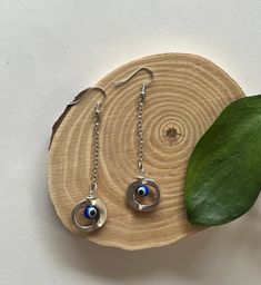 ~These earrings are made with silver tarnish resistant chain and findings. Topped off with glass evil eye beads. ~Earring backs included. Glass Evil Eye, Evil Eye Beads, Evil Eye Earrings, Eye Beads, Eye Earrings, Wood Ornaments, Earring Backs, Evil Eye, Beaded Earrings