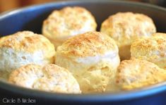 some biscuits are in a blue bowl on a table and it looks like they have been baked