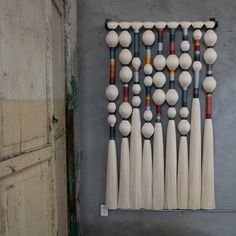 an art piece made out of baseball bats and balls